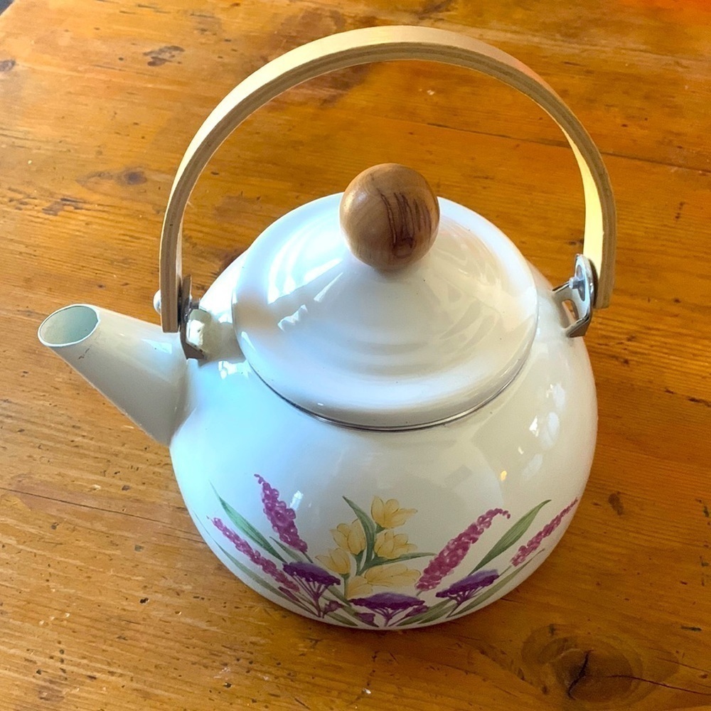 Metal kettle with flowers​​​​​​​​